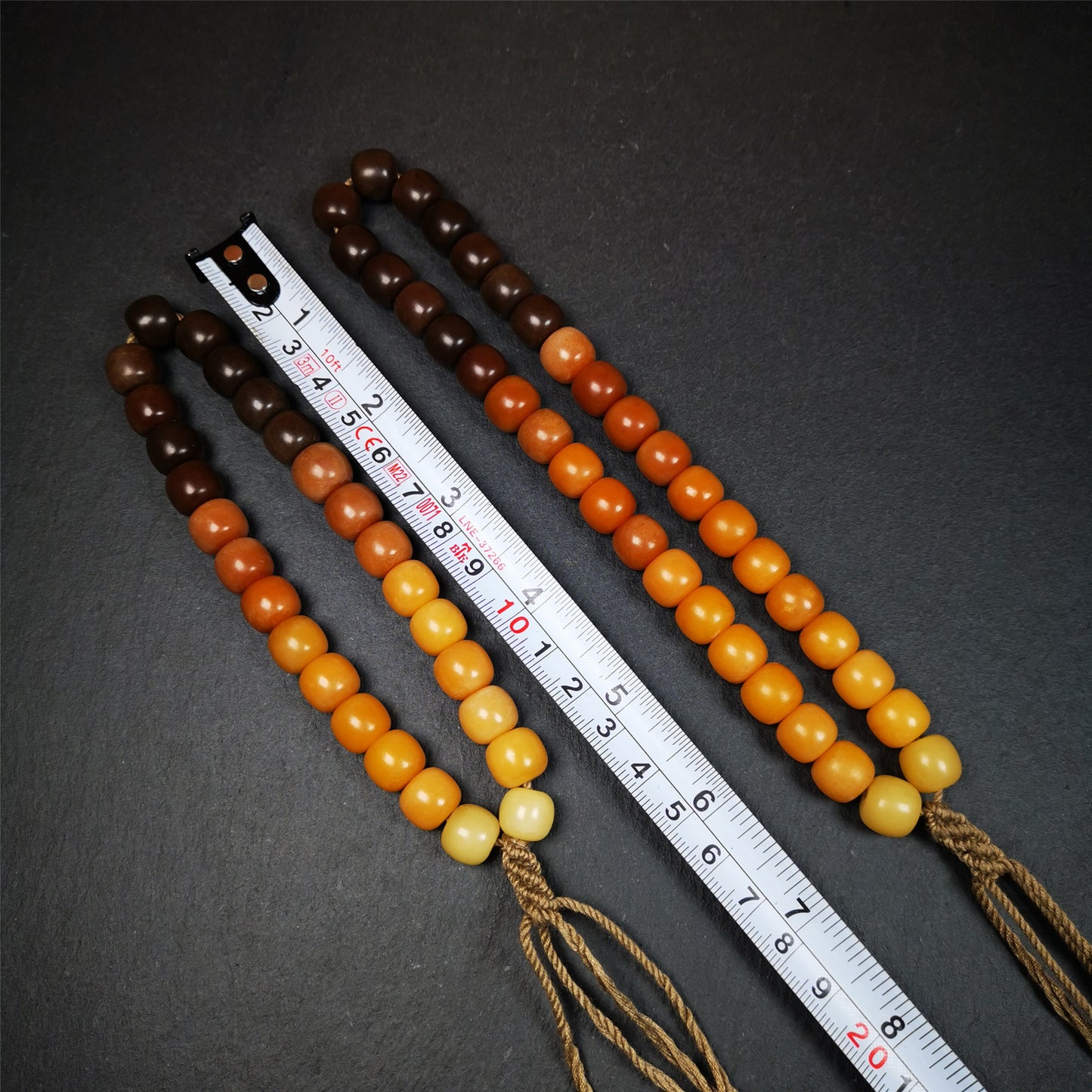 This mala was made by Tibetan craftsmen and come from Hepo Town, Baiyu County, the birthplace of the famous Tibetan handicrafts. It is made of Corypha Linn Seeds, diameter of 10mm / 0.4",gradient color, designed as a couple set,the large size for men, small size for women.