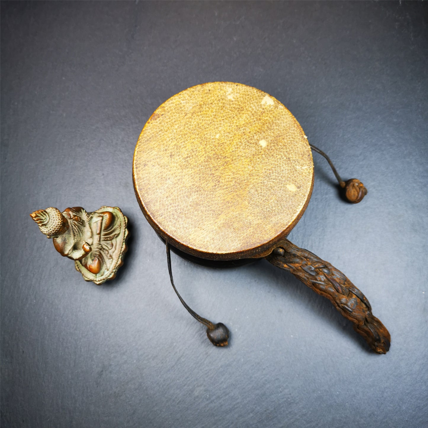 This Old Damaru Chod Drum was collected from a vallage in Gerze Tibet,about 60 years old,used and blessed by lama. It is made of Wood,Sheepskin and leather cord,the drumsticks are also made of leather cords, the drum skin shows different colors because one side of it was damaged and repaired long time ago.