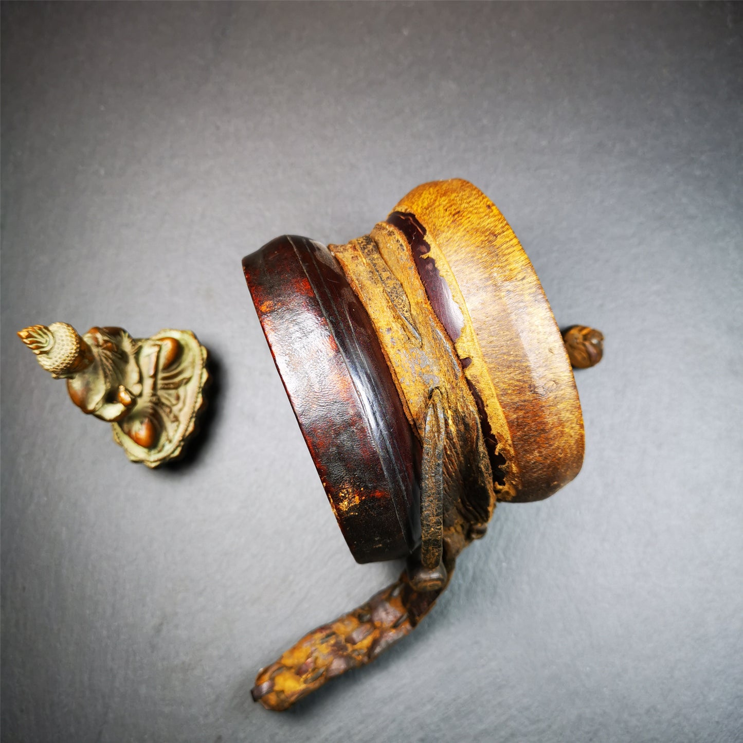 This Old Damaru Chod Drum was collected from a vallage in Gerze Tibet,about 60 years old,used and blessed by lama. It is made of Wood,Sheepskin and leather cord,the drumsticks are also made of leather cords, the drum skin shows different colors because one side of it was damaged and repaired long time ago.