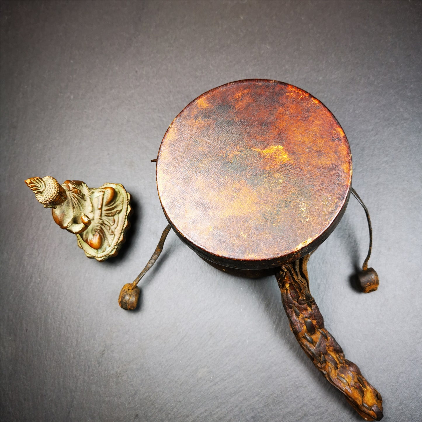 This Old Damaru Chod Drum was collected from a vallage in Gerze Tibet,about 60 years old,used and blessed by lama. It is made of Wood,Sheepskin and leather cord,the drumsticks are also made of leather cords, the drum skin shows different colors because one side of it was damaged and repaired long time ago.