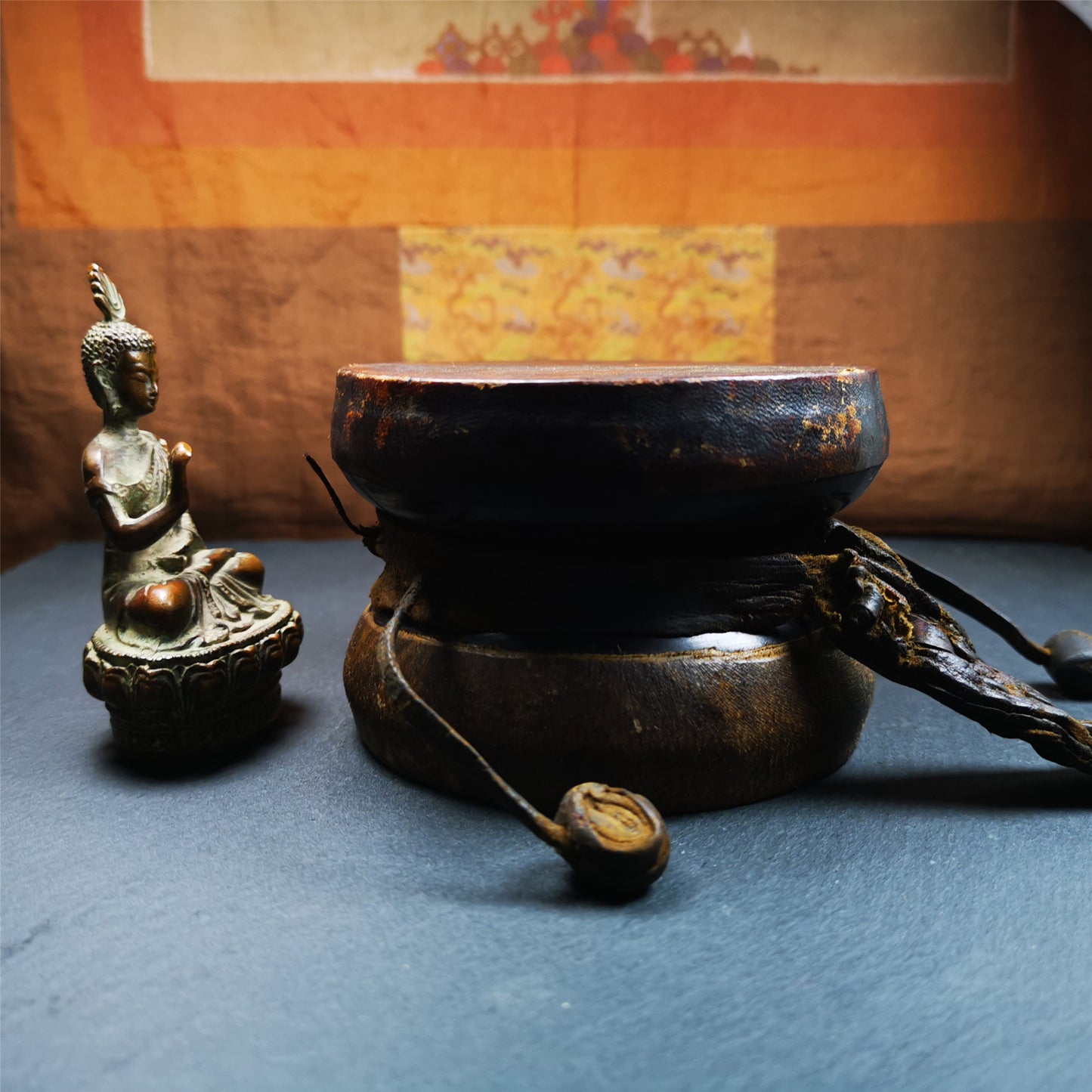 This Old Damaru Chod Drum was collected from a vallage in Gerze Tibet,about 60 years old,used and blessed by lama. It is made of Wood,Sheepskin and leather cord,the drumsticks are also made of leather cords, the drum skin shows different colors because one side of it was damaged and repaired long time ago.