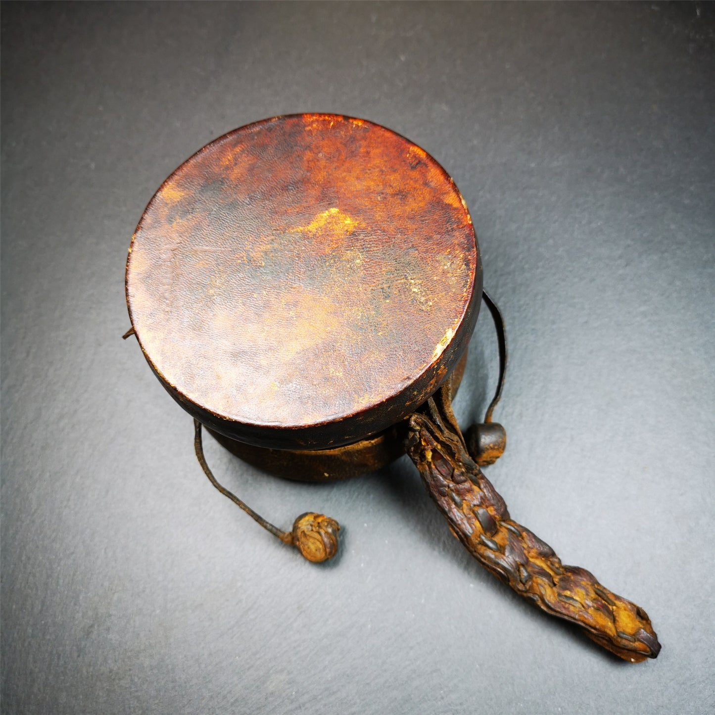 This Old Damaru Chod Drum was collected from a vallage in Gerze Tibet,about 60 years old,used and blessed by lama. It is made of Wood,Sheepskin and leather cord,the drumsticks are also made of leather cords, the drum skin shows different colors because one side of it was damaged and repaired long time ago.