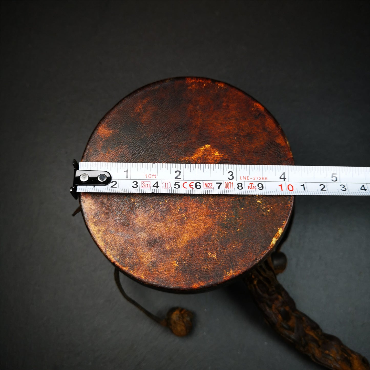 This Old Damaru Chod Drum was collected from a vallage in Gerze Tibet,about 60 years old,used and blessed by lama. It is made of Wood,Sheepskin and leather cord,the drumsticks are also made of leather cords, the drum skin shows different colors because one side of it was damaged and repaired long time ago.