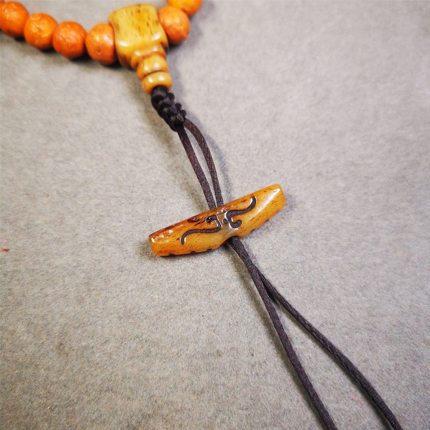 This unique bone carved ruyi pendant is made by Tibetan craftsmen in Hepo Township, Baiyu County, the birthplace of the famous Tibetan handicrafts.  You can use it as a spacer bead on mala,or pendant bead under guru bead. Also can be use as amulet pendant or keychain.