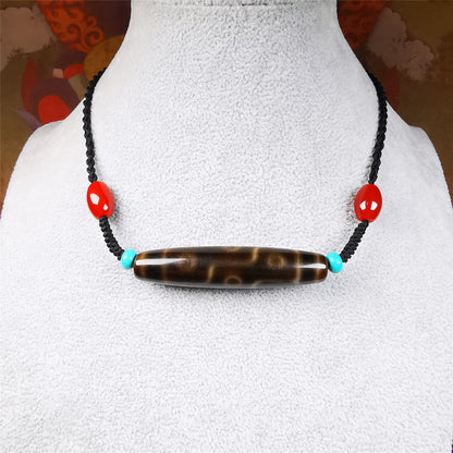 This necklace was hand-woven by Tibetans from Baiyu County, the main bead is a brown color 9 eyes dzi, paired with 2 turquoise beads and 2 red agate beads,about 30 years old. The length of the necklace can be adjusted, the maximum circumference is about 60cm.