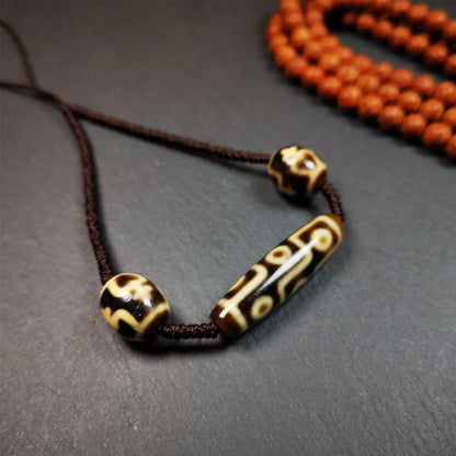 This necklace was hand-woven by Tibetans from Baiyu County, the main bead is a 9-eye dzi, paired with 2 treasure vase dalo dzi beads,about 30 years old. It can be worn not only as a fashionable accessory but also holds cultural and religious significance.