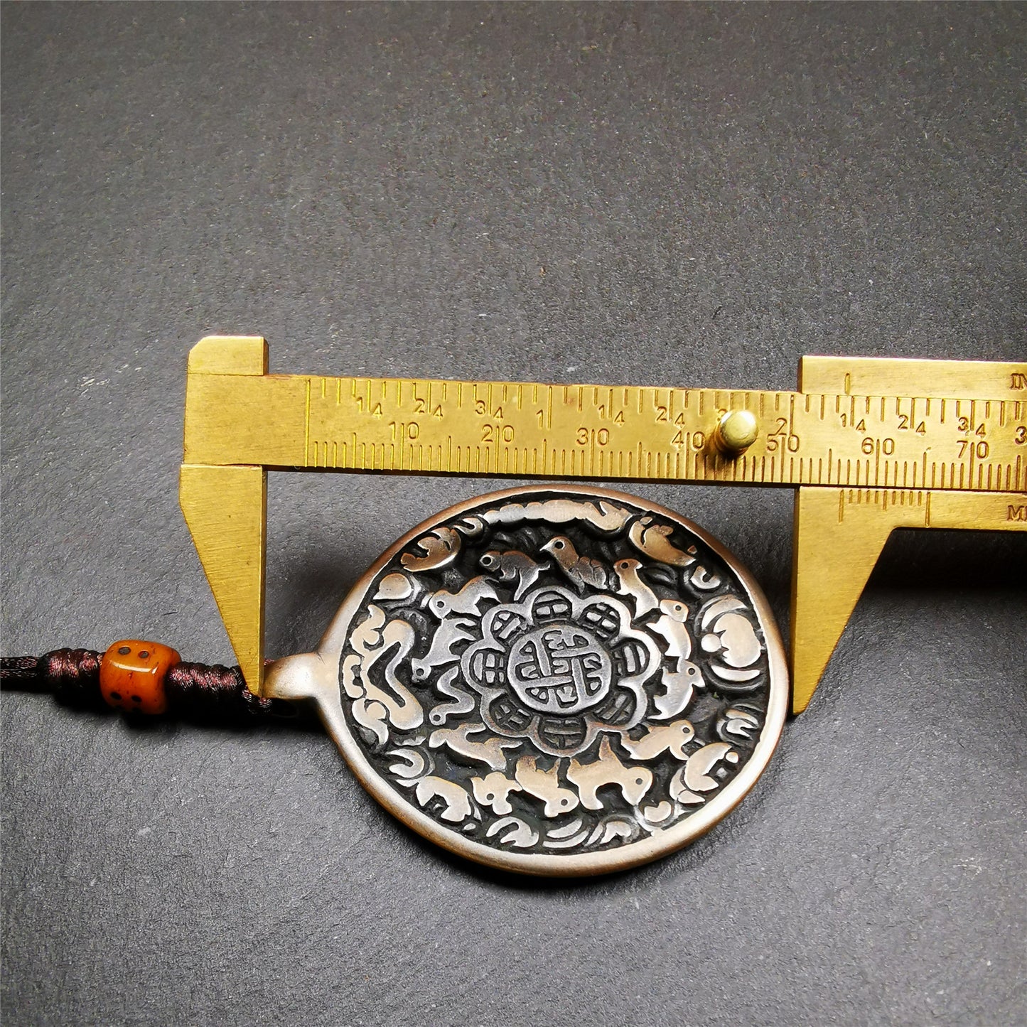 This unique tibetan melong badge was collected from Baiyu Monastery for 30 years. It's a Astrology Protective Amulet Pendant,made of cold iron. The pattern is Tibetan Budhist Protective Amulet Pendant - SIPAHO(srid pa ho).