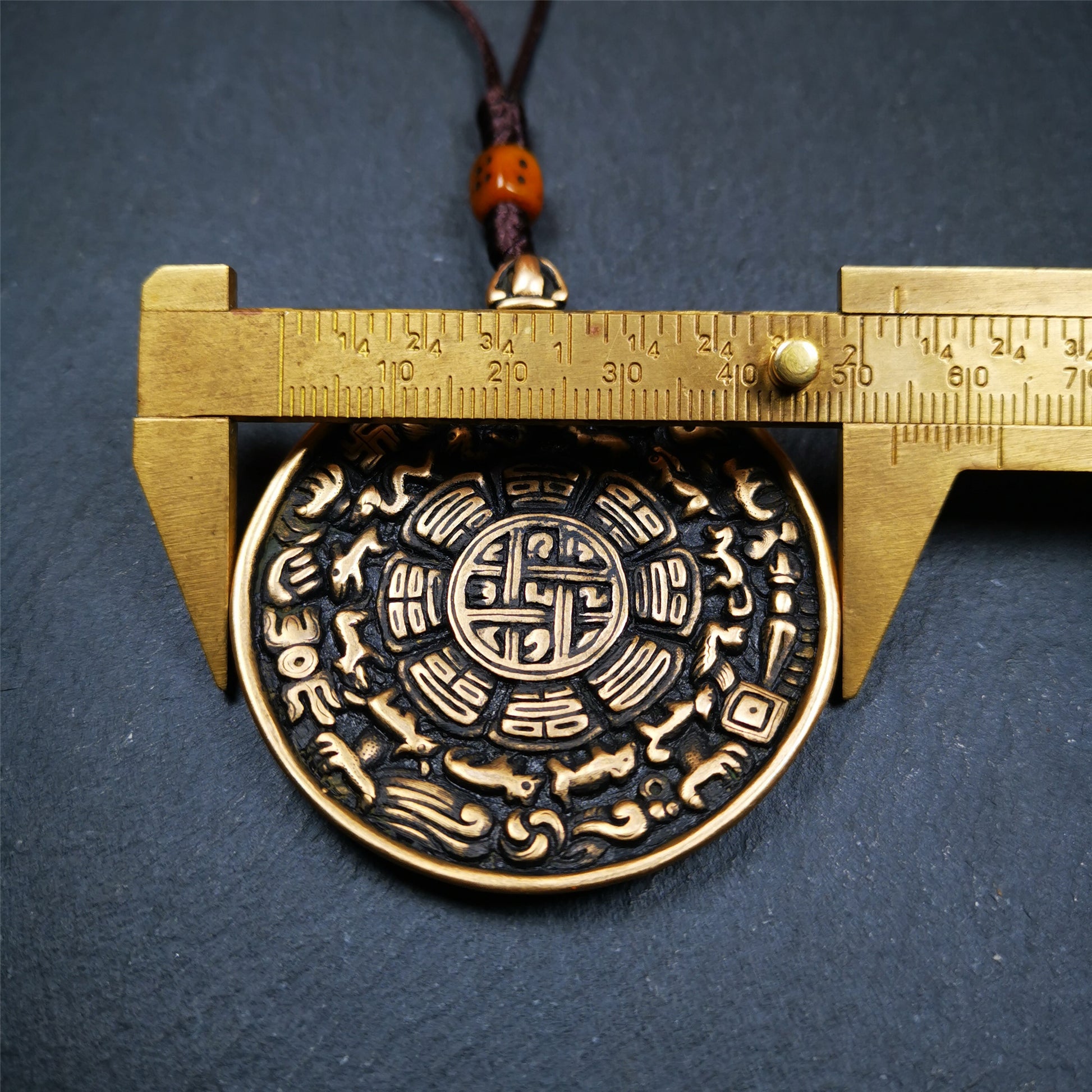 This unique tibetan melong badge was handmade by Tibetan Artist from Baiyu County. It's a Astrology Protective Amulet Pendant,made of brass,the front pattern is Tibetan Budhist Protective Amulet Pendant - SIPAHO(srid pa ho),a bone carved dice bead in the middle of the lanyard.
