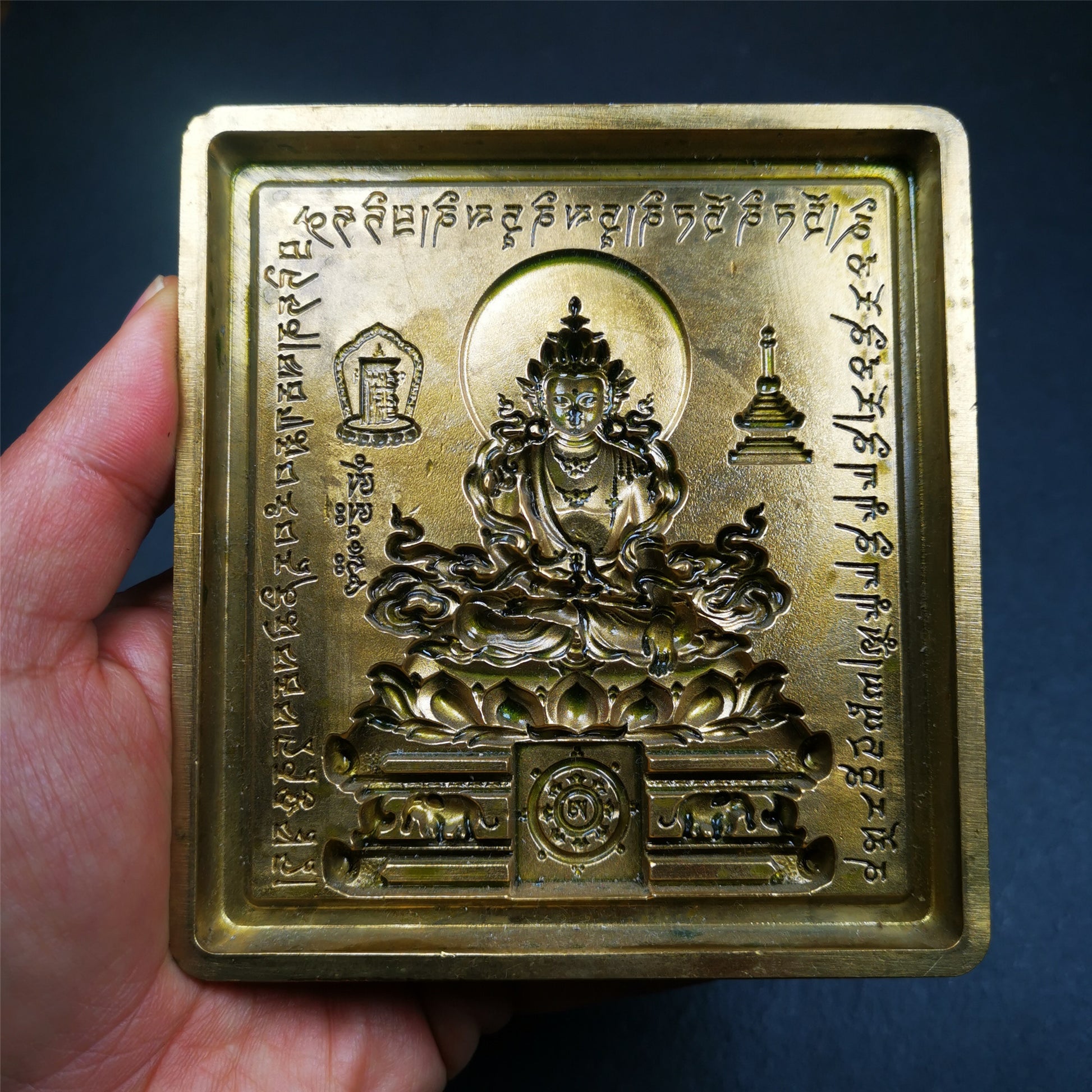 This unique Akshobhya Tsa-Tsa buddha statue mold is made by Tibetan craftsmen in Hepo Township, Baiyu County. With this exquisite mold, you can use clay to make your own Buddha statue as a decoration or consecration. The statue that you make from your moulds can be left plain or painted.