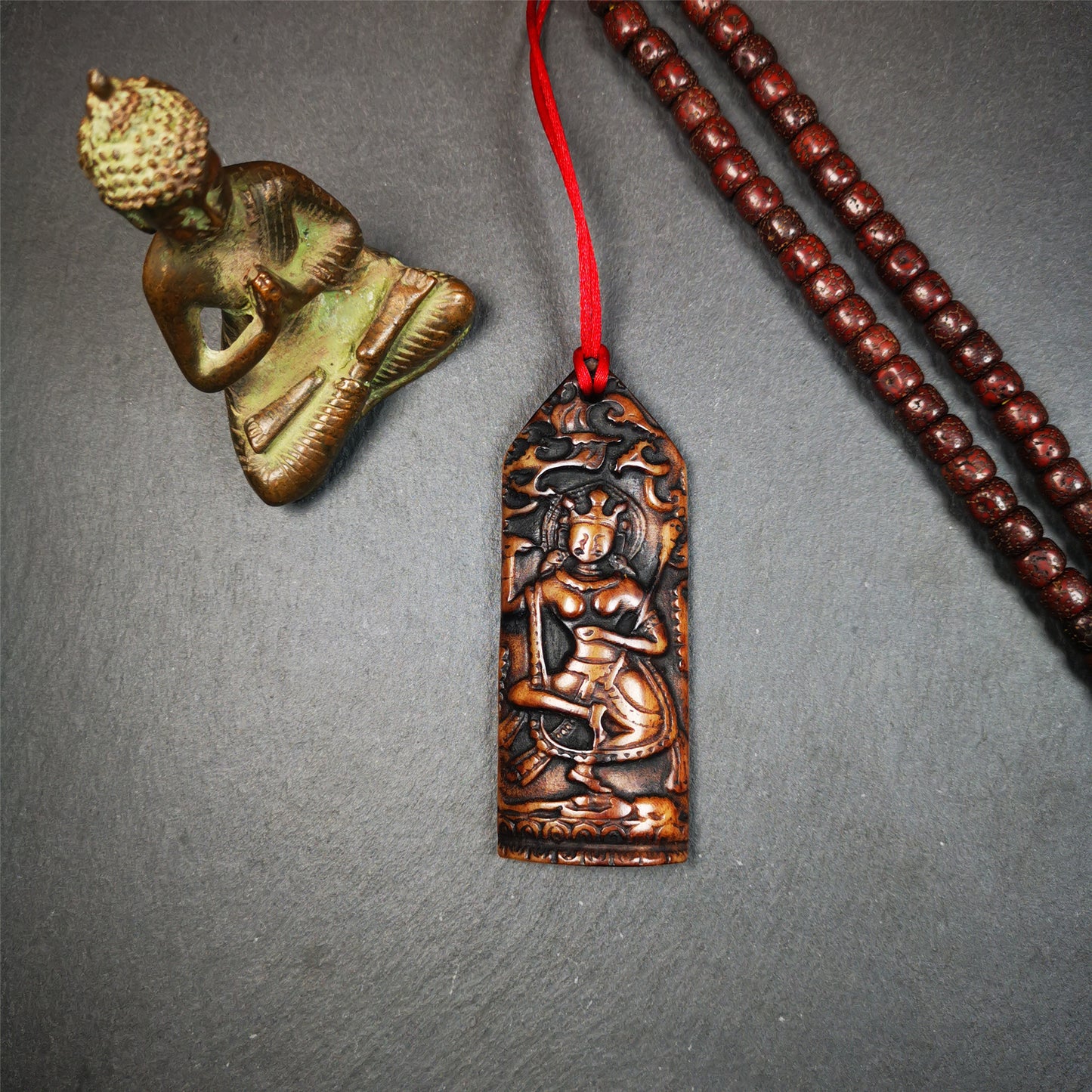 This bone carved Troma Nagmo amulet was collected from Gerze Tibet, hand carved by Tibetan Craft man,about 30 years old. Troma Nagmo literally means the Black Wrathful Lady. She is included in the Dharmapala pantheon as a form of Vajravarahi. 