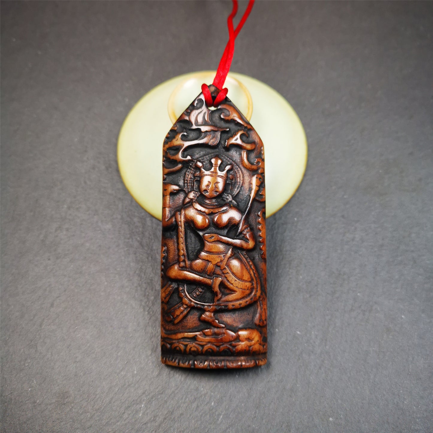 This bone carved Troma Nagmo amulet was collected from Gerze Tibet, hand carved by Tibetan Craft man,about 30 years old. Troma Nagmo literally means the Black Wrathful Lady. She is included in the Dharmapala pantheon as a form of Vajravarahi. 