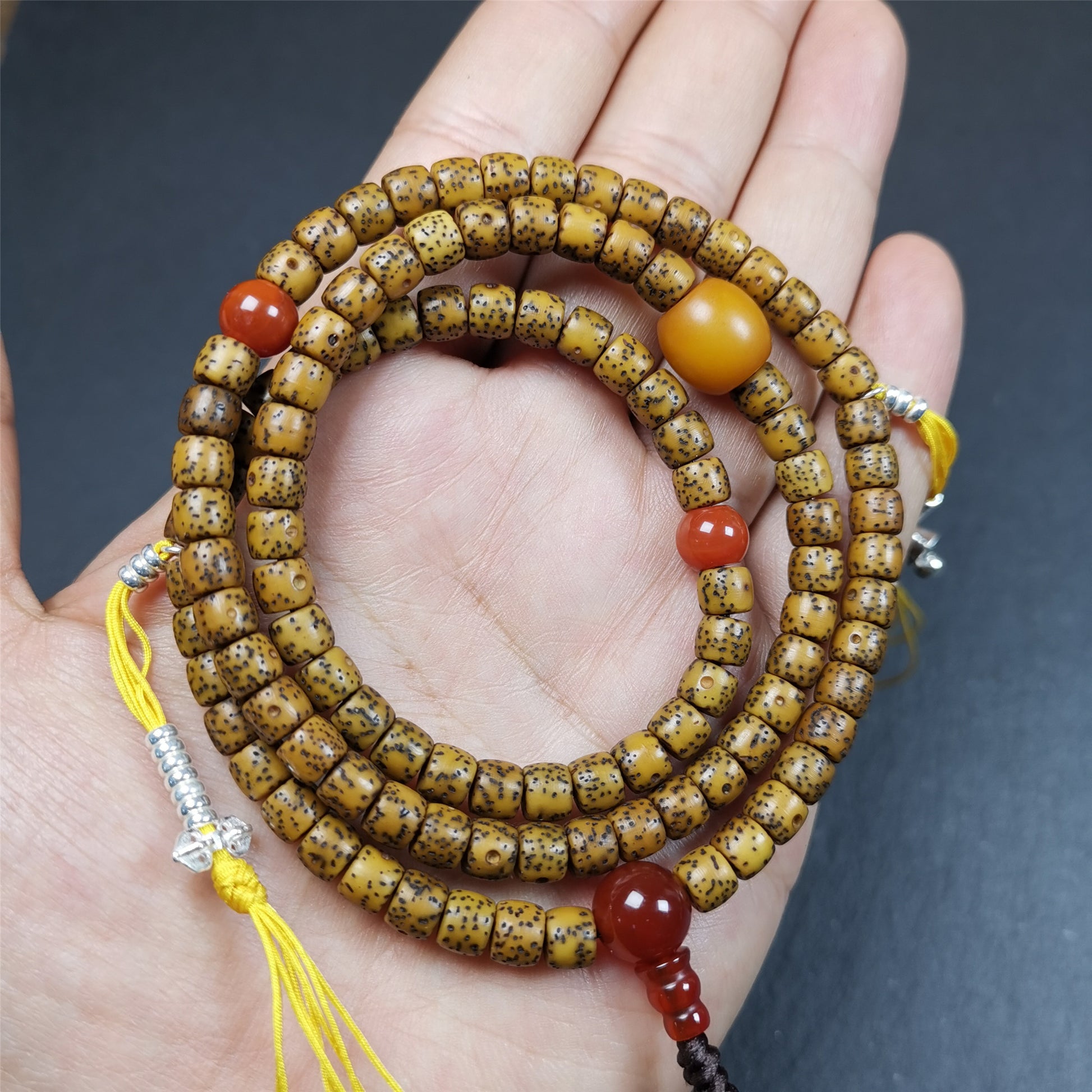 This old lotus seed mala was handmade from tibetan crafts man in Baiyu County,about 20 years old. It's composed of 108 lotus seed beads,then add some agate beads,1 pair of silver bead counters,and agate guru bead on it.