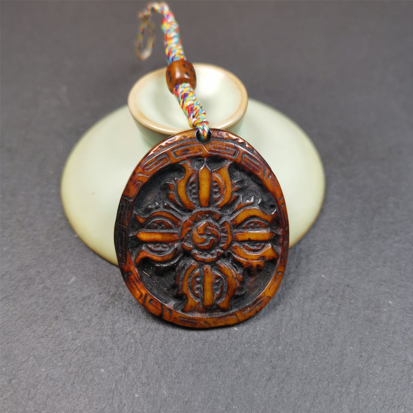 This cross vajra badge amulet was hand carved by Tibetan craftsmen and come from Hepo Town, Baiyu County, the birthplace of the famous Tibetan handicrafts. It is made of yak bone, completely hand-carved, very delicate.