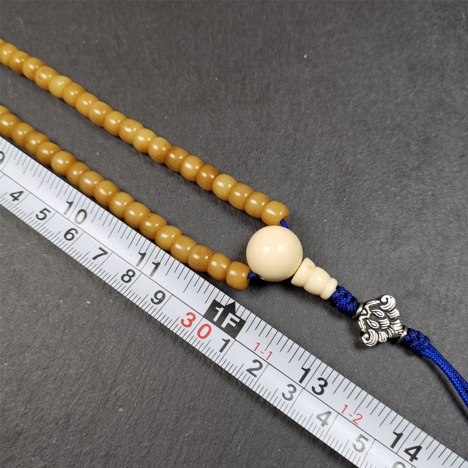 This yak bone mala was handmade from tibetan crafts man in Baiyu County. It's composed of 108 pcs 7mm bone beads,with agate and turquoise beads,guru bead,and mani jewel pendant.