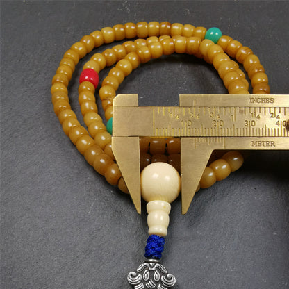 This yak bone mala was handmade from tibetan crafts man in Baiyu County. It's composed of 108 pcs 7mm bone beads,with agate and turquoise beads,guru bead,and mani jewel pendant.
