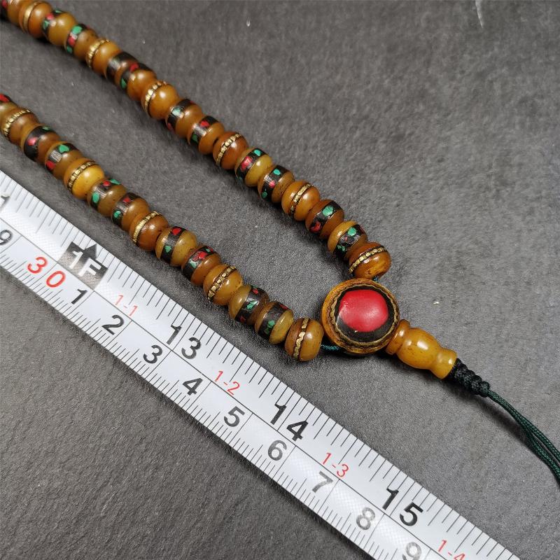This mala bracelet was made by Tibetan craftsmen. It is made of yak bone,copper wire inlaid colorful color,108 beads diameter of 8mm / 0.32",circumference is 72cm / 28",with old agate beads.