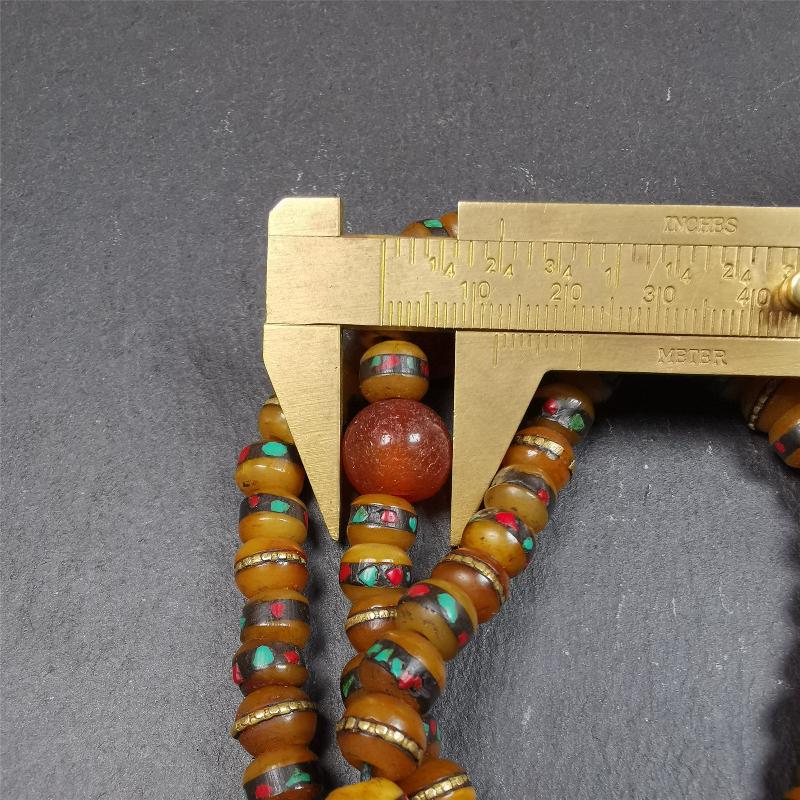 This mala bracelet was made by Tibetan craftsmen. It is made of yak bone,copper wire inlaid colorful color,108 beads diameter of 8mm / 0.32",circumference is 72cm / 28",with old agate beads.
