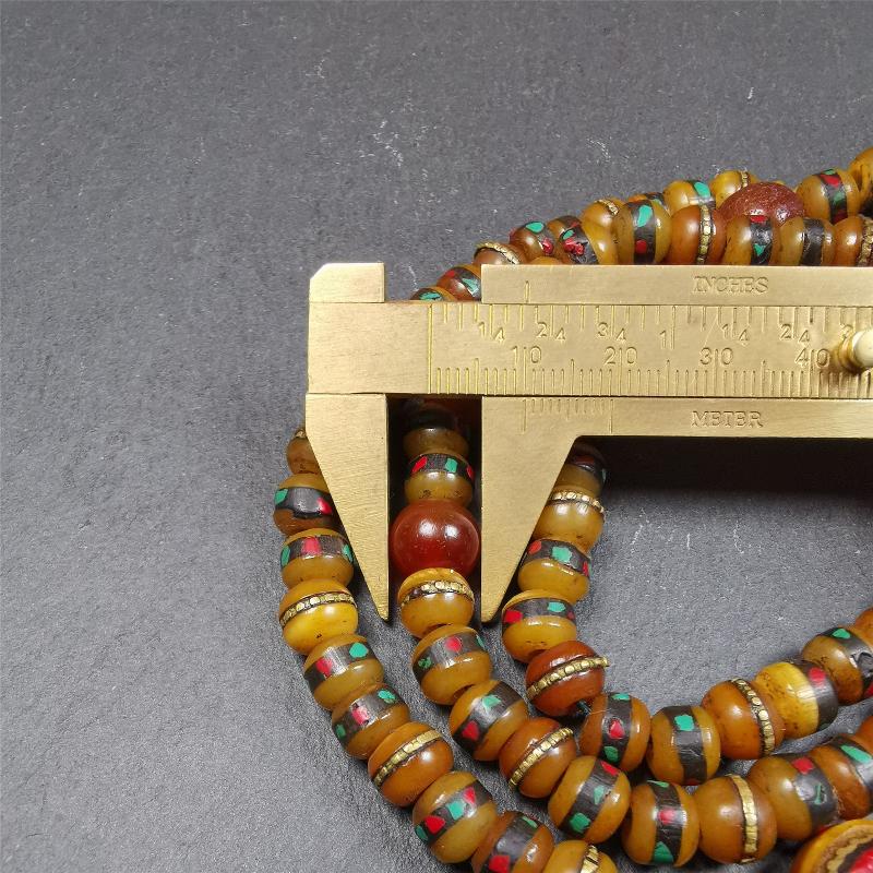 This mala bracelet was made by Tibetan craftsmen. It is made of yak bone,copper wire inlaid colorful color,108 beads diameter of 8mm / 0.32",circumference is 72cm / 28",with old agate beads.