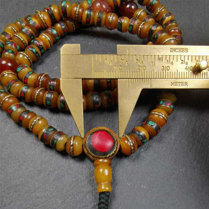 This mala bracelet was made by Tibetan craftsmen. It is made of yak bone,copper wire inlaid colorful color,108 beads diameter of 8mm / 0.32",circumference is 72cm / 28",with old agate beads.