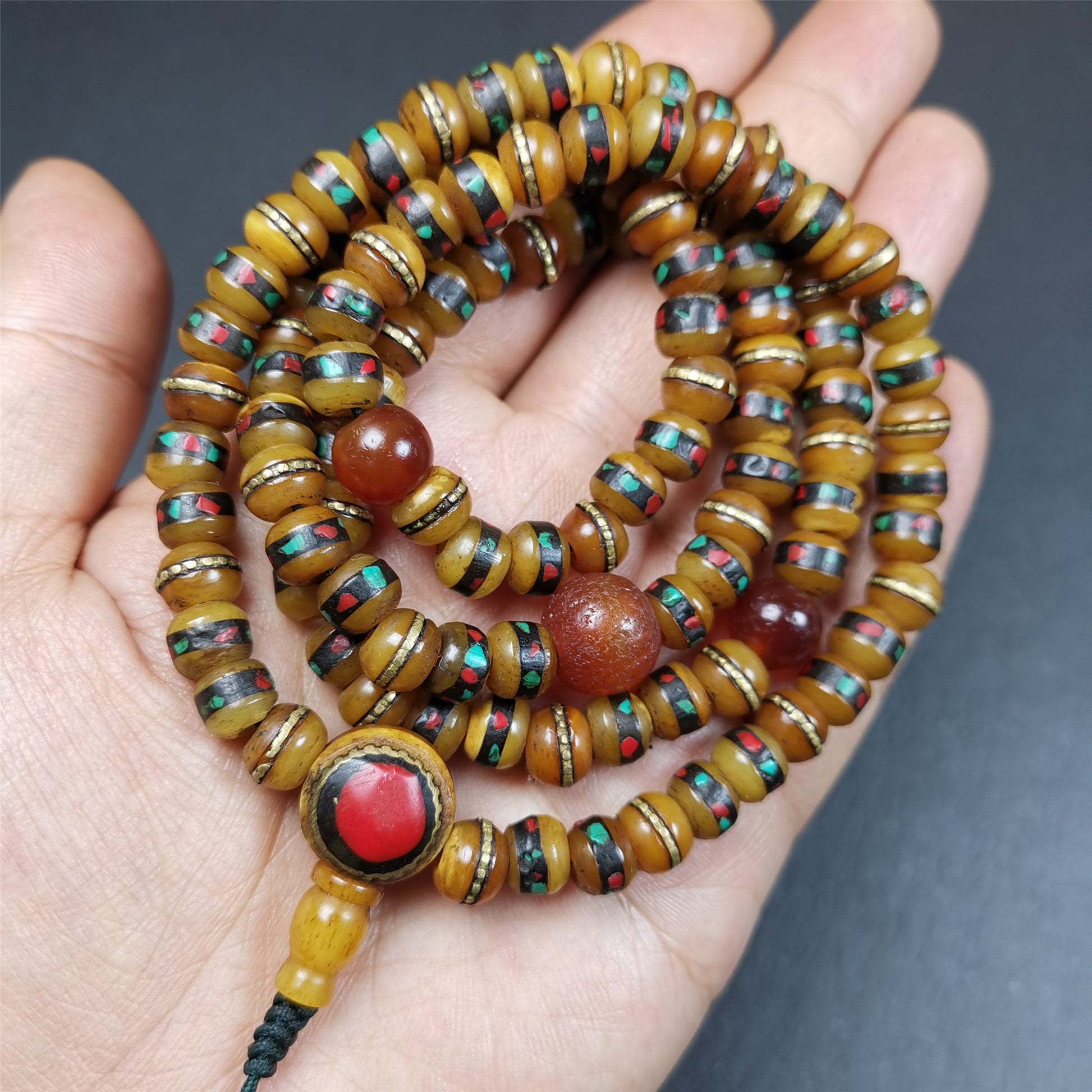 This mala bracelet was made by Tibetan craftsmen. It is made of yak bone,copper wire inlaid colorful color,108 beads diameter of 8mm / 0.32",circumference is 72cm / 28",with old agate beads.