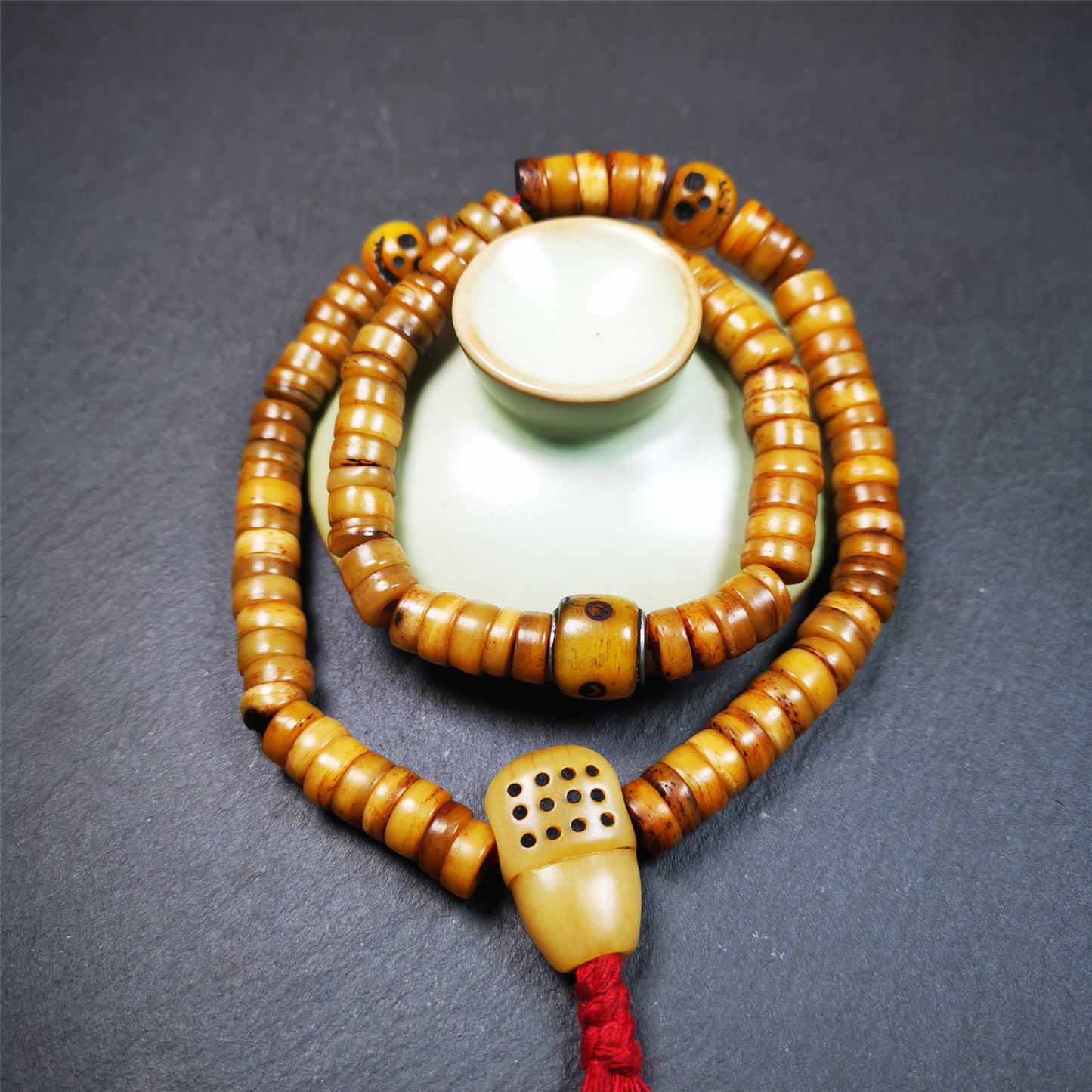 This yak bone mala was handmade from tibetan crafts man in Baiyu County,about 30 years old. It's composed of 108 pcs 9mm bone beads,with bone carved beads,guru bead.