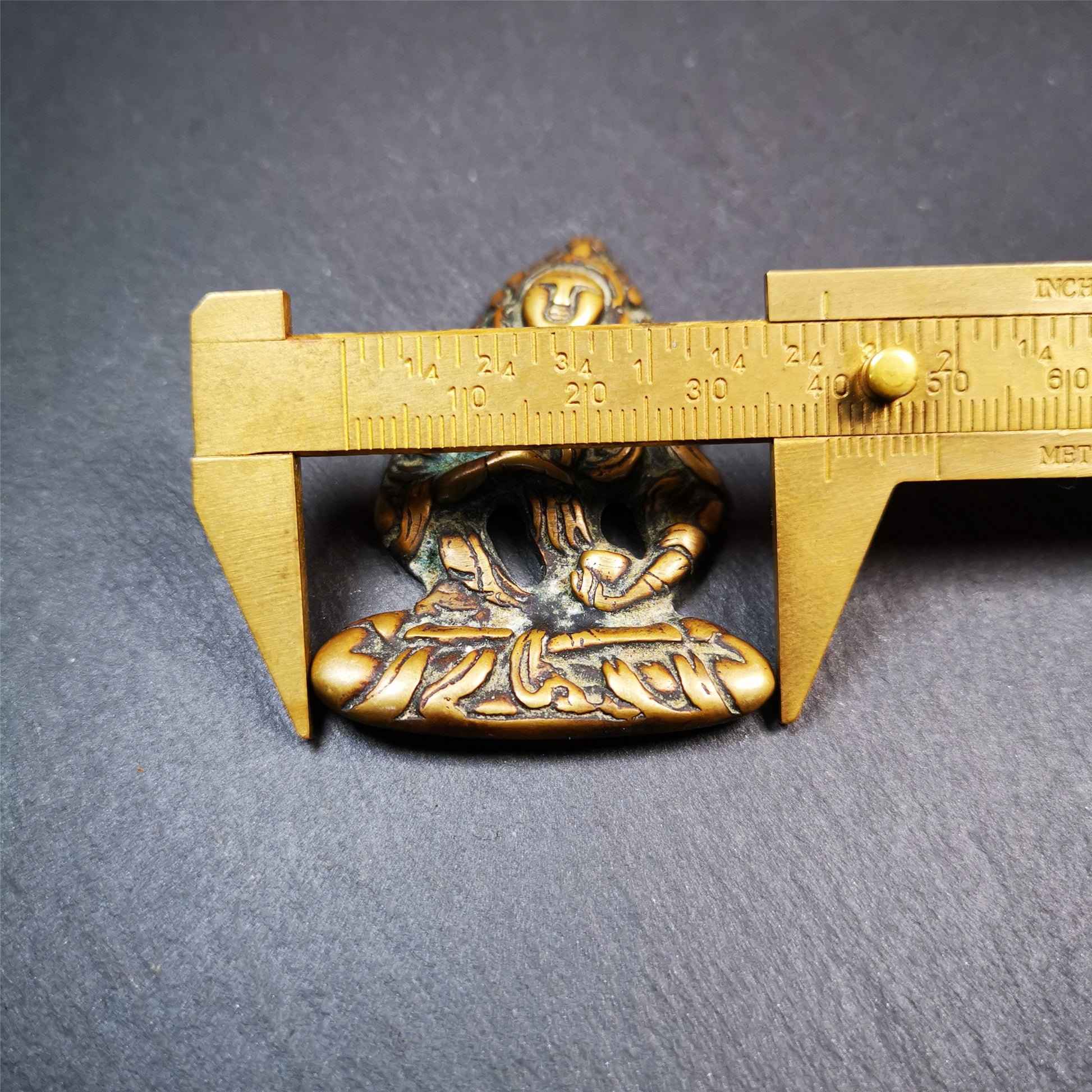 This Vajrasattva statue was collected from Derge,Tibet. It's a badge or pendant,made of copper,brown color, size is 2.24" × 1.57". You can make it into a necklace,or bag hanging