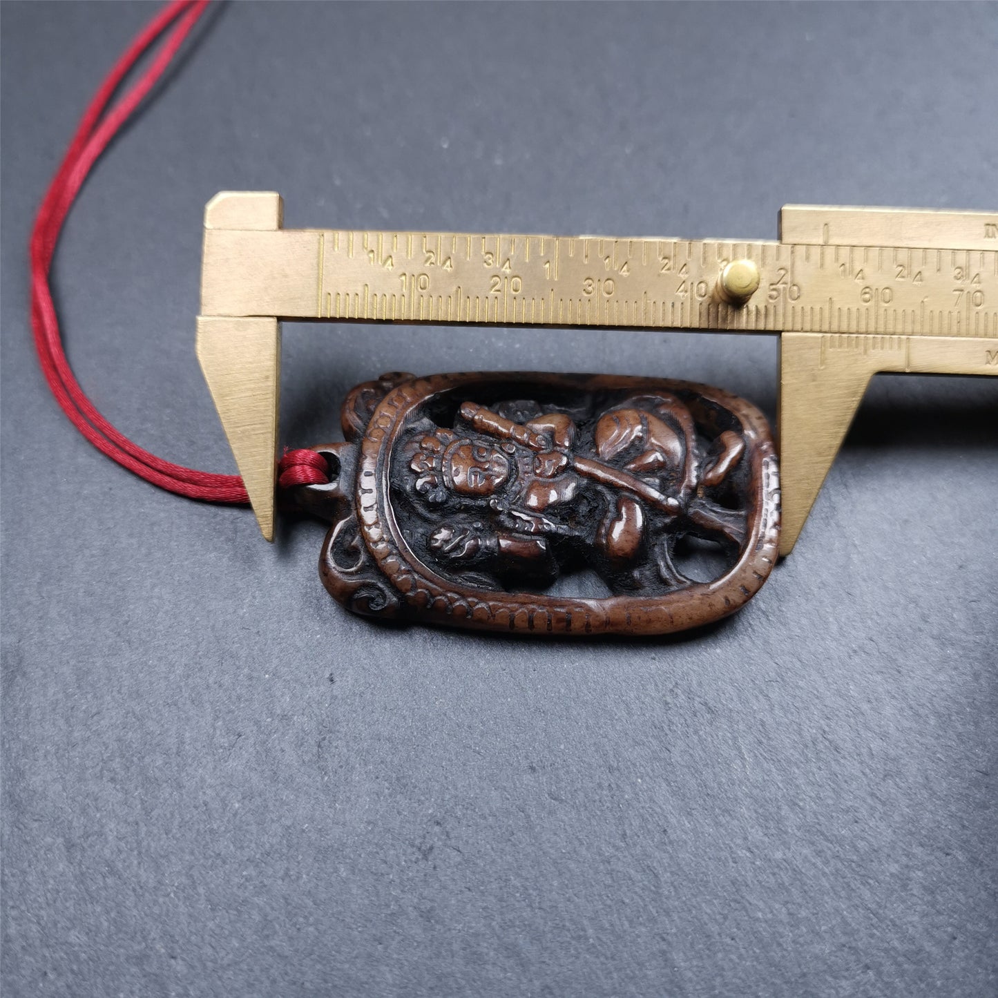 This Troma Nagmo amulet was collected from Gerze Tibet, hand carved by Tibetan Craft man. It is made of yak bone,brown color,size is 2.16" × 1.3". You can make it necklace,or just put into your shrine. Troma Nagmo literally means the Black Wrathful Lady. She is included in the Dharmapala pantheon as a form of Vajravarahi. She is also the feminine embodiment of w