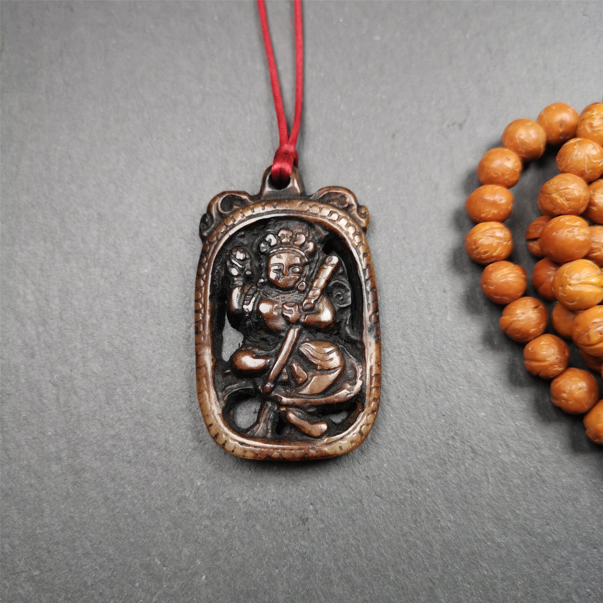 This Troma Nagmo amulet was collected from Gerze Tibet, hand carved by Tibetan Craft man. It is made of yak bone,brown color,size is 2.16" × 1.3". You can make it necklace,or just put into your shrine. Troma Nagmo literally means the Black Wrathful Lady. She is included in the Dharmapala pantheon as a form of Vajravarahi. She is also the feminine embodiment of w