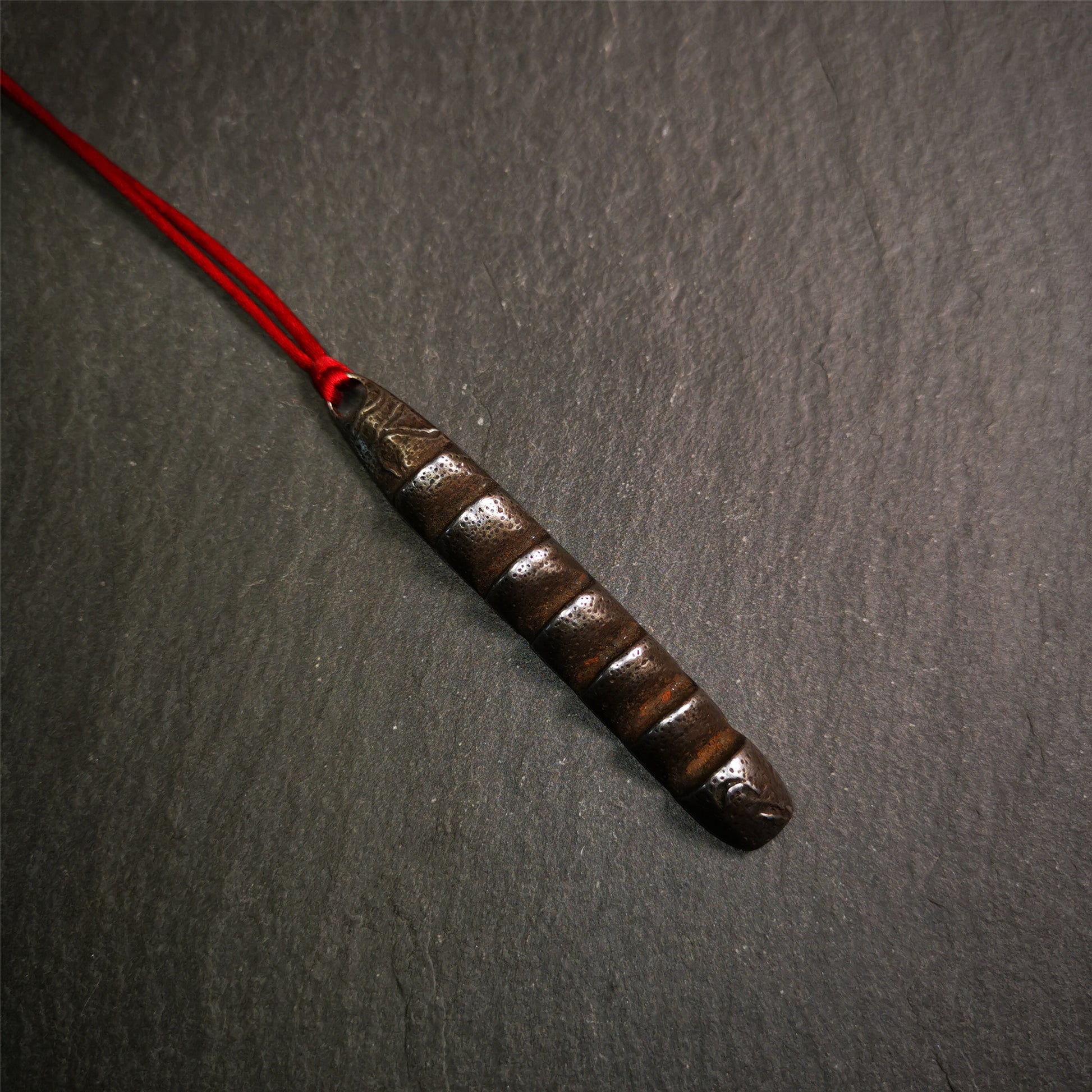 This unique Ladder pendant is made by Tibetan craftsmen. It is made of cold iron and copper, black color,the shape is Tibetan Ladder of Heaven,length is 66mm. You can make it into a pendant,keychain, or just put it on your desk,as an ornament.