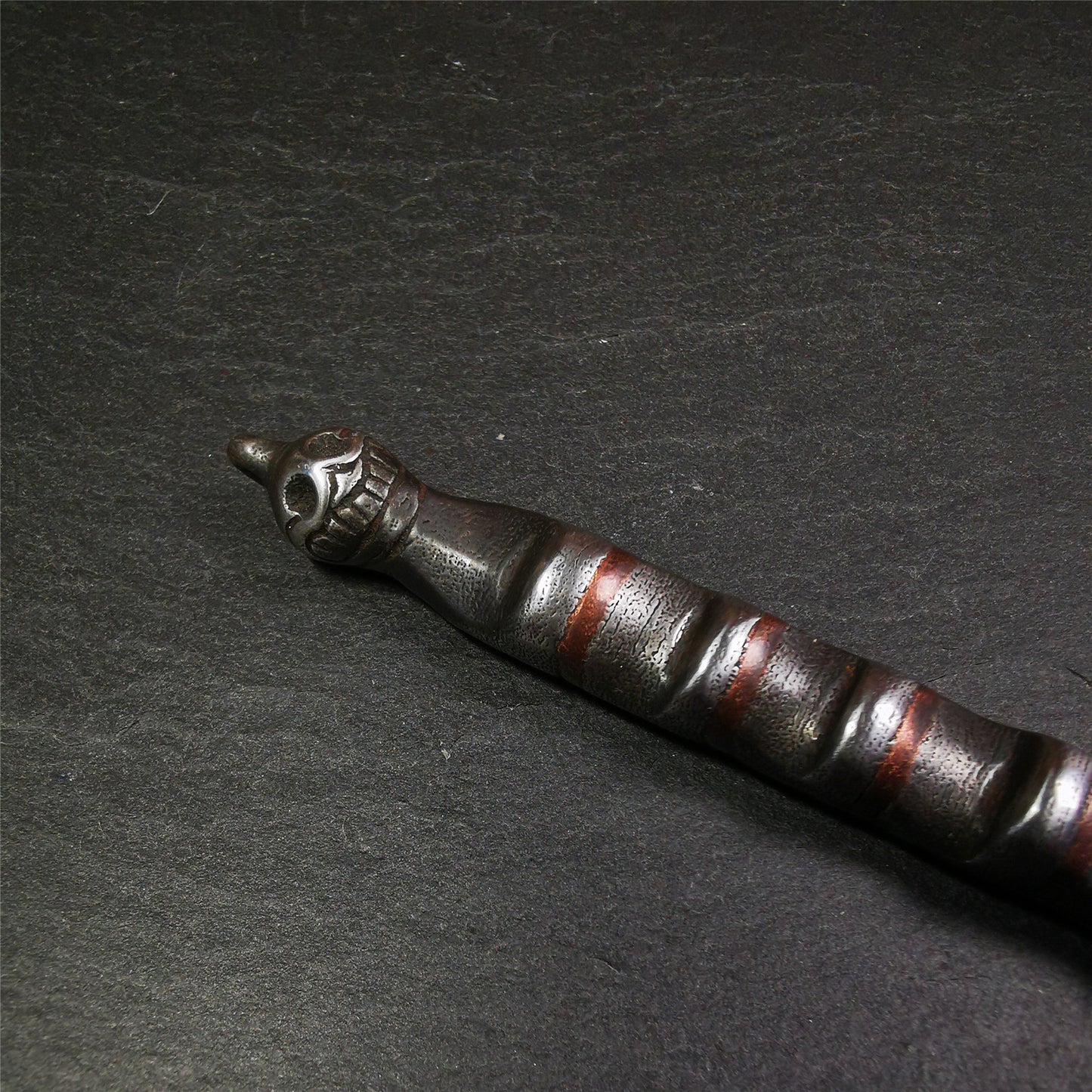 This unique Ladder pendant is made by Tibetan craftsmen in Hepo Township, Baiyu County. It is made of cold iron and copper, black color,the shape is Tibetan Ladder of Heaven,a skull on the top,length is 11cm / 4.33 inches.  The ladder of heaven represents that Tibetans can pass their wishes and blessings to their relatives in the sky, and reach the Paradise of Paradise or the Pure Land of Buddhism as soon as possible.