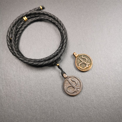 These amulet were  handmade by Tibetan craftsmen from Tibet in 1990's. It's made of copper/brass,brown/yellow color,diameter is 0.83 inch,comes with a leather cord. You can make it into a necklace,or bag hanging