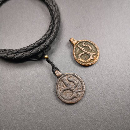 These amulet were  handmade by Tibetan craftsmen from Tibet in 1990's. It's made of copper/brass,brown/yellow color,diameter is 0.83 inch,comes with a leather cord. You can make it into a necklace,or bag hanging