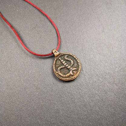 These amulet were  handmade by Tibetan craftsmen from Tibet in 1990's. It's made of copper/brass,brown/yellow color,diameter is 0.83 inch,comes with a leather cord. You can make it into a necklace,or bag hanging