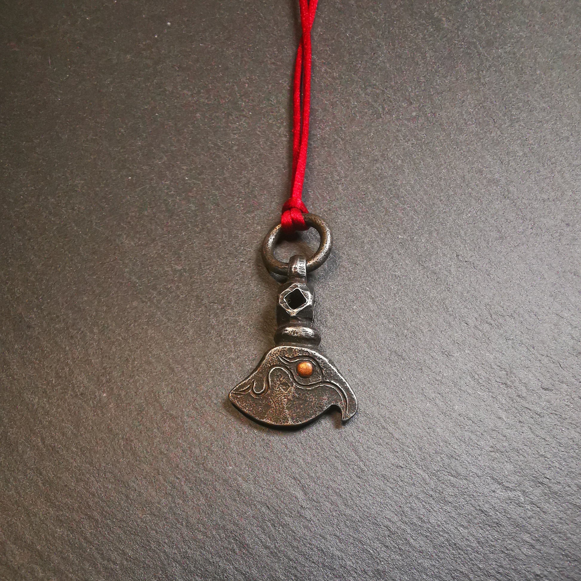 This kartika amulet was made by Tibetan craftsmen in Hepo Township, Baiyu County, the birthplace of the famous Tibetan handicrafts. It's made of cold iron, inlaid copper,carved with could pattern,size is 1.1 × 0.8 inches. You can make it into a necklace, or a keychain, or just put it on your desk,as an ornament.