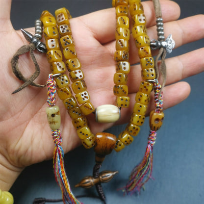 This unique mala was made by Tibetan craftsmen,blessed by lama. It is made of yak bone, yellow color,108 dice beads diameter of 8mm / 0.32",circumference is 84cm / 33",and lots of accessories on mala.