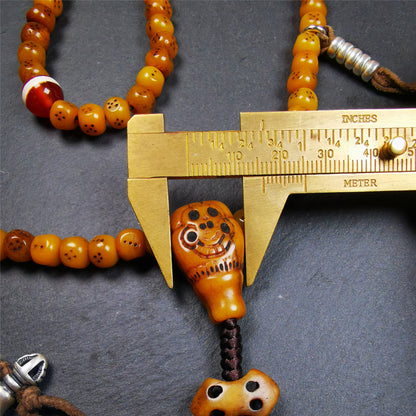 This mala bracelet was made by Tibetan craftsmen. It is made of yak bone, yellow color,108 dice beads diameter of 7mm / 0.27",circumference is 68cm / 26.8",and lots of accessories on it.