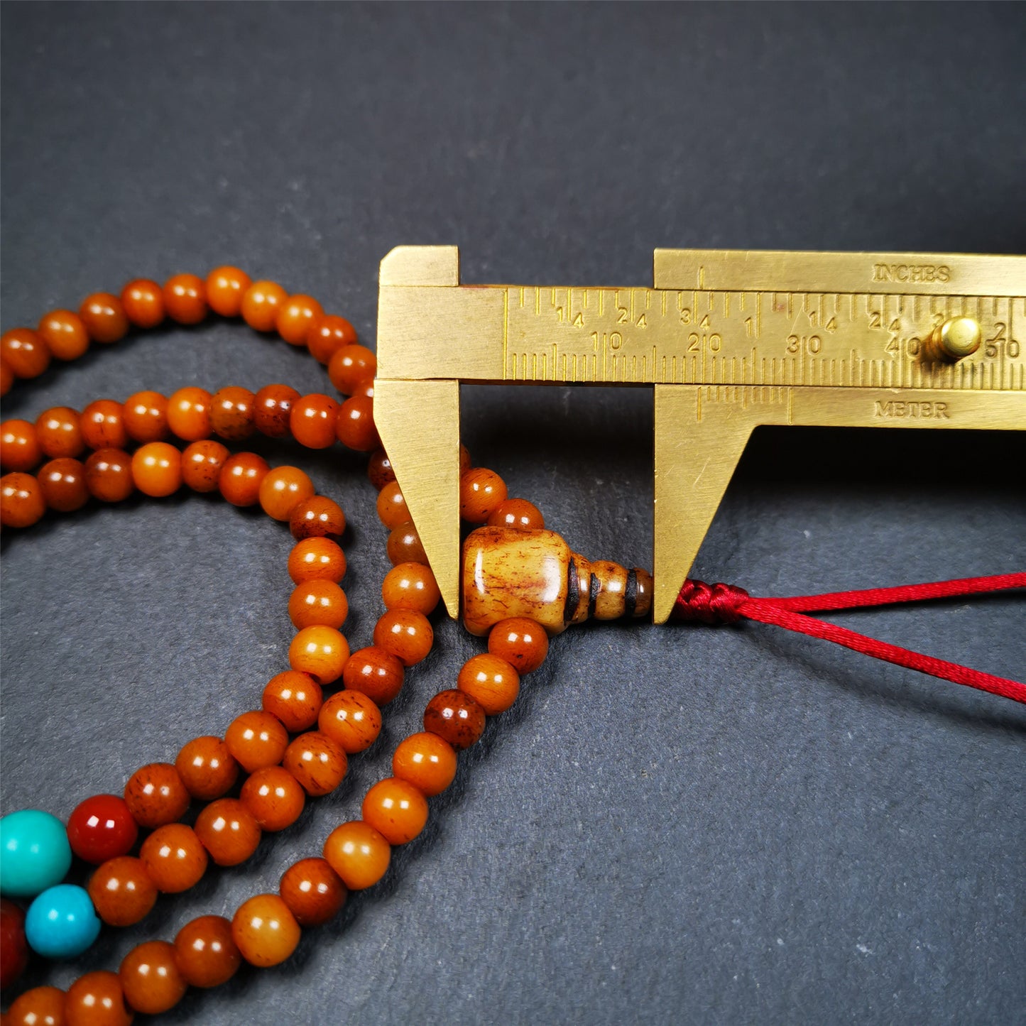 This yak bone mala was handmade from tibetan crafts man in Baiyu County,about 30 years old. It's composed of 108 pcs small size 6mm bone beads,with agate and turquoise beads,bone guru bead.Circumference about 61cm,24 inches.