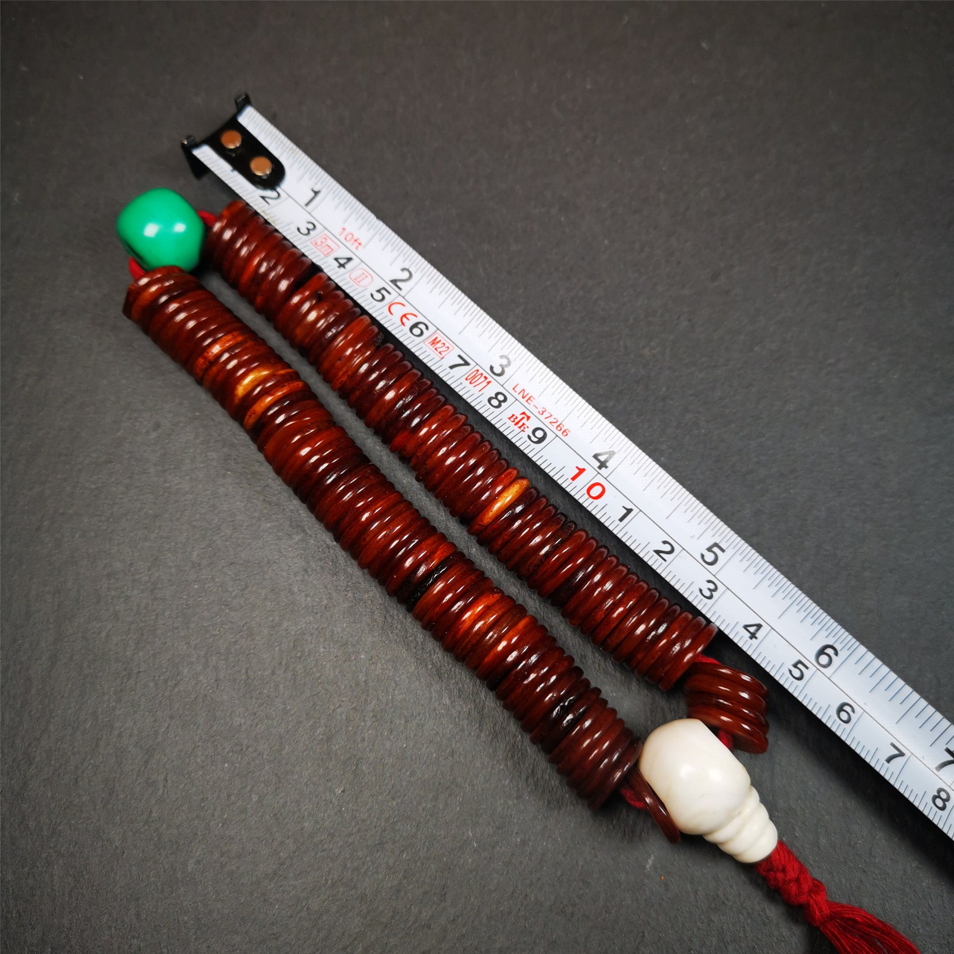 This bone carved mala beads is made by Tibetan craftsmen and come from Hepo Town, Baiyu County,about 30 years Old. It has 108 flat shape beads,1 turquoise spacer bead,and 1 shell guru bead,all hand carved.