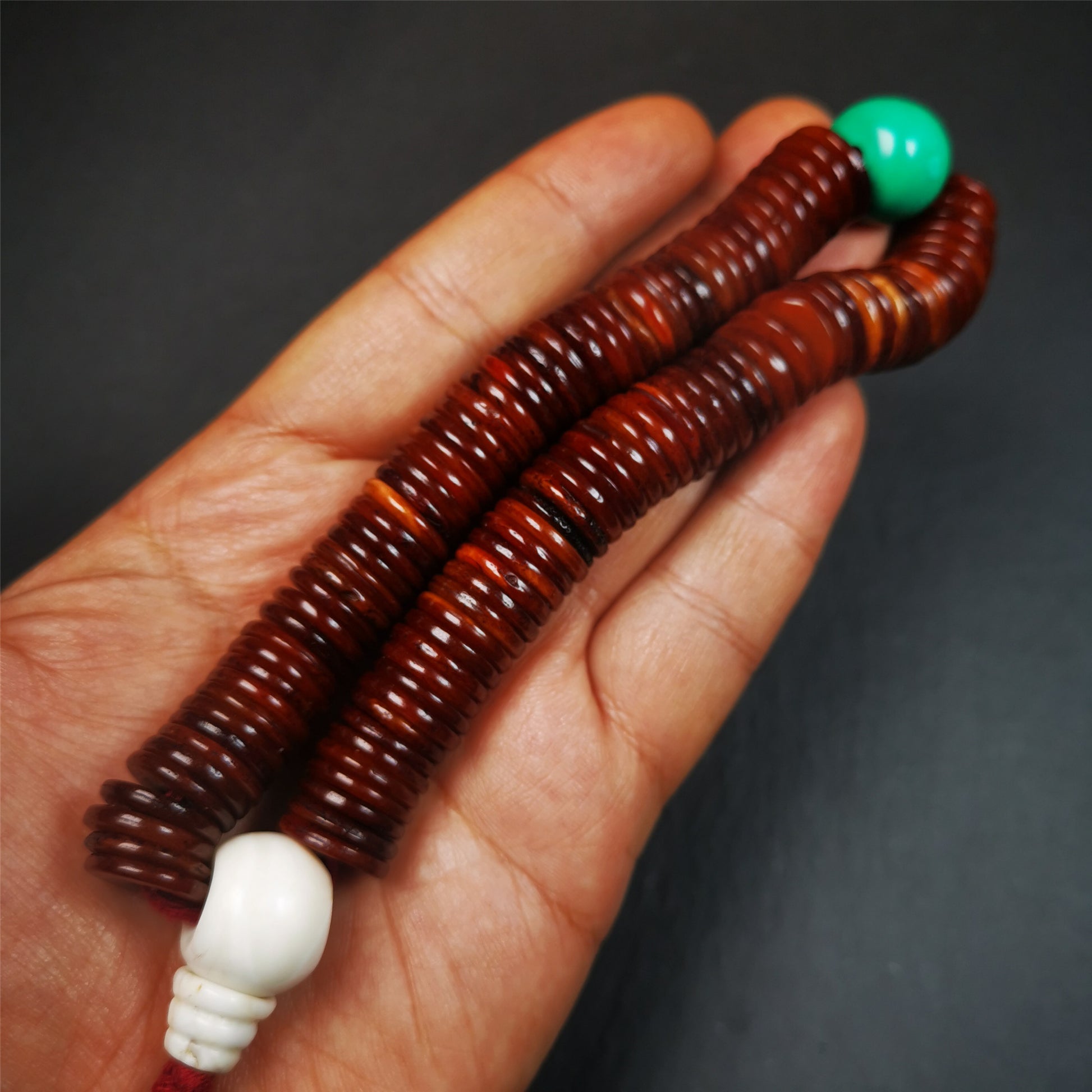 This bone carved mala beads is made by Tibetan craftsmen and come from Hepo Town, Baiyu County,about 30 years Old. It has 108 flat shape beads,1 turquoise spacer bead,and 1 shell guru bead,all hand carved.