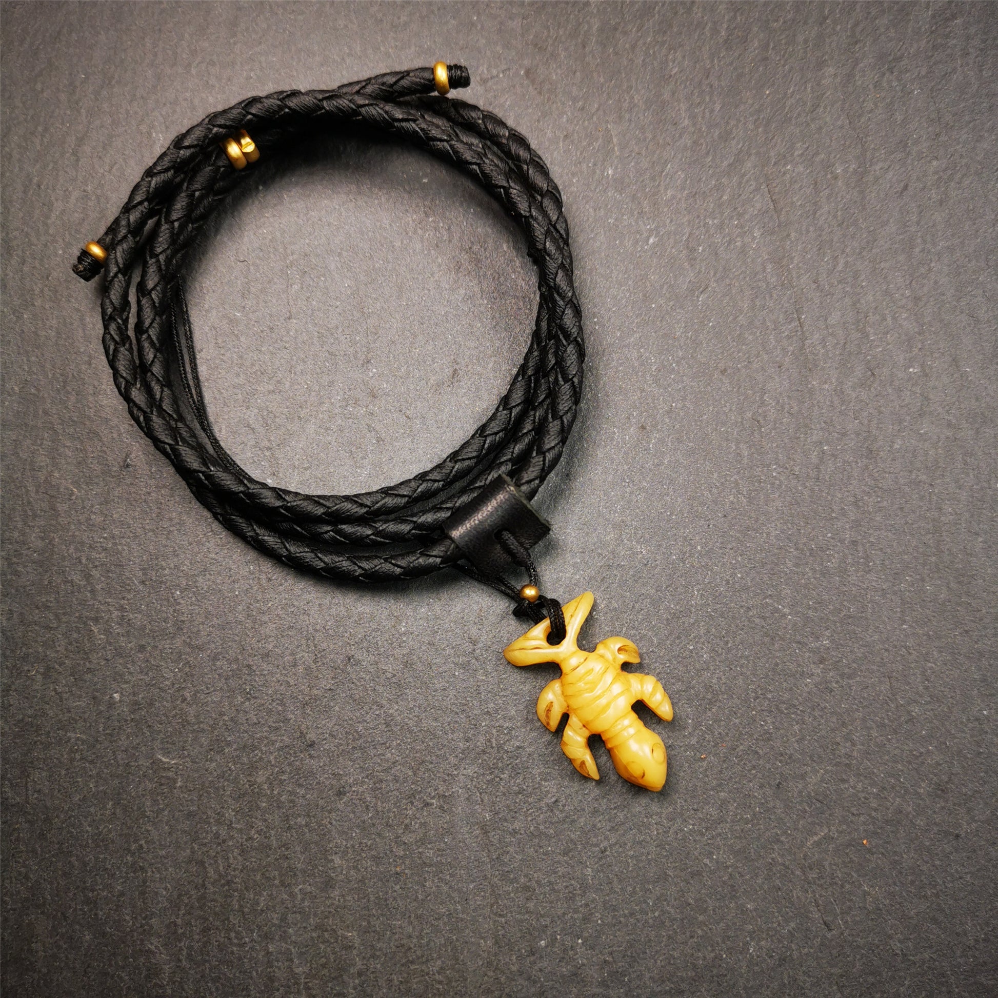 This unique bone carved Scorpion Guru pendant is made by Tibetan craftsmen in Hepo Township, Baiyu County, the birthplace of the Tibetan handicrafts. It's carved yak bone,yellow color,1.2 inch height. You can make it into necklace,or mala pendant.