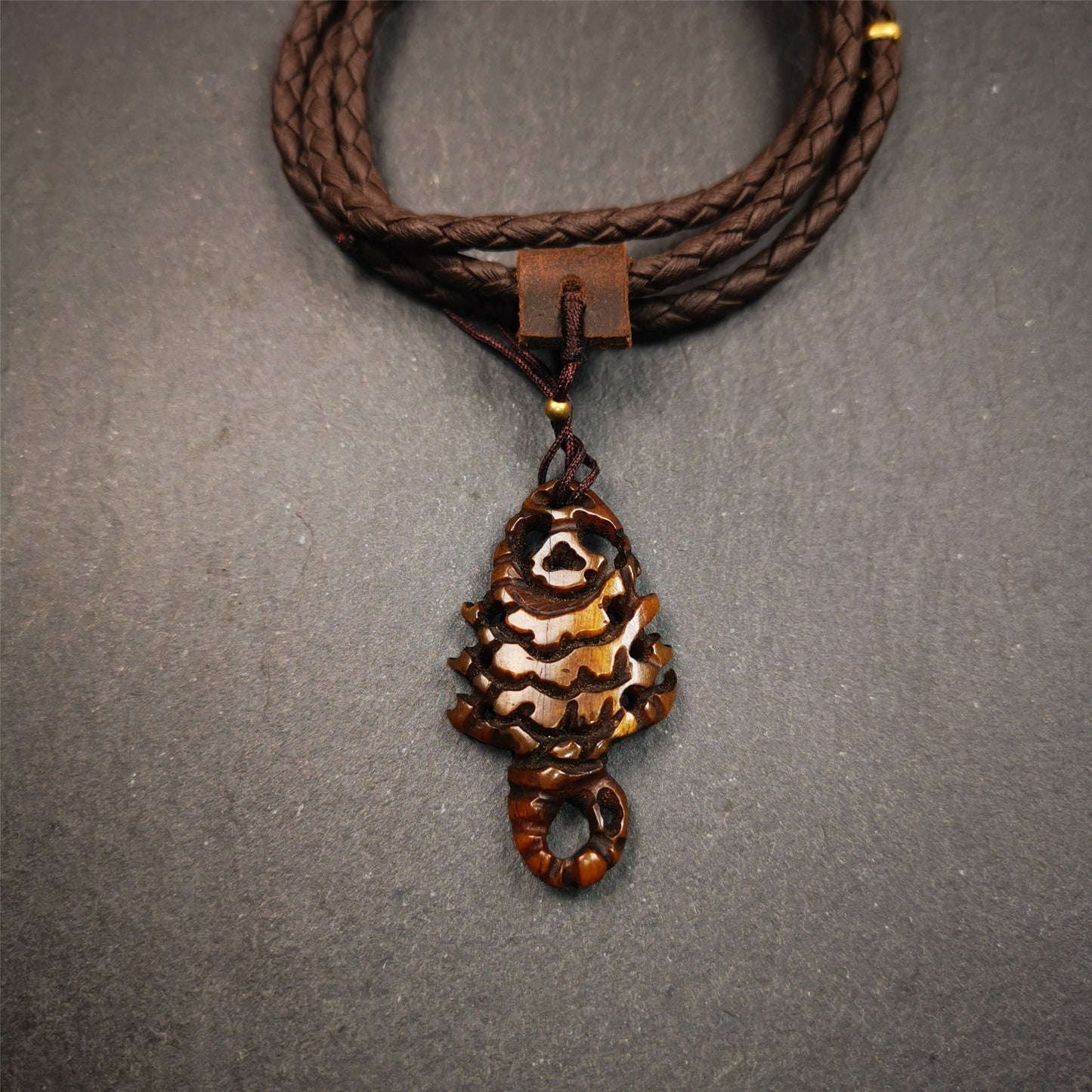 This unique bone carved Scorpion Guru pendant is made by Tibetan craftsmen in Hepo Township, Baiyu County, the birthplace of the famous Tibetan handicrafts. It's carved yak bone,brown color,1.77 inch height. You can make it into necklace.