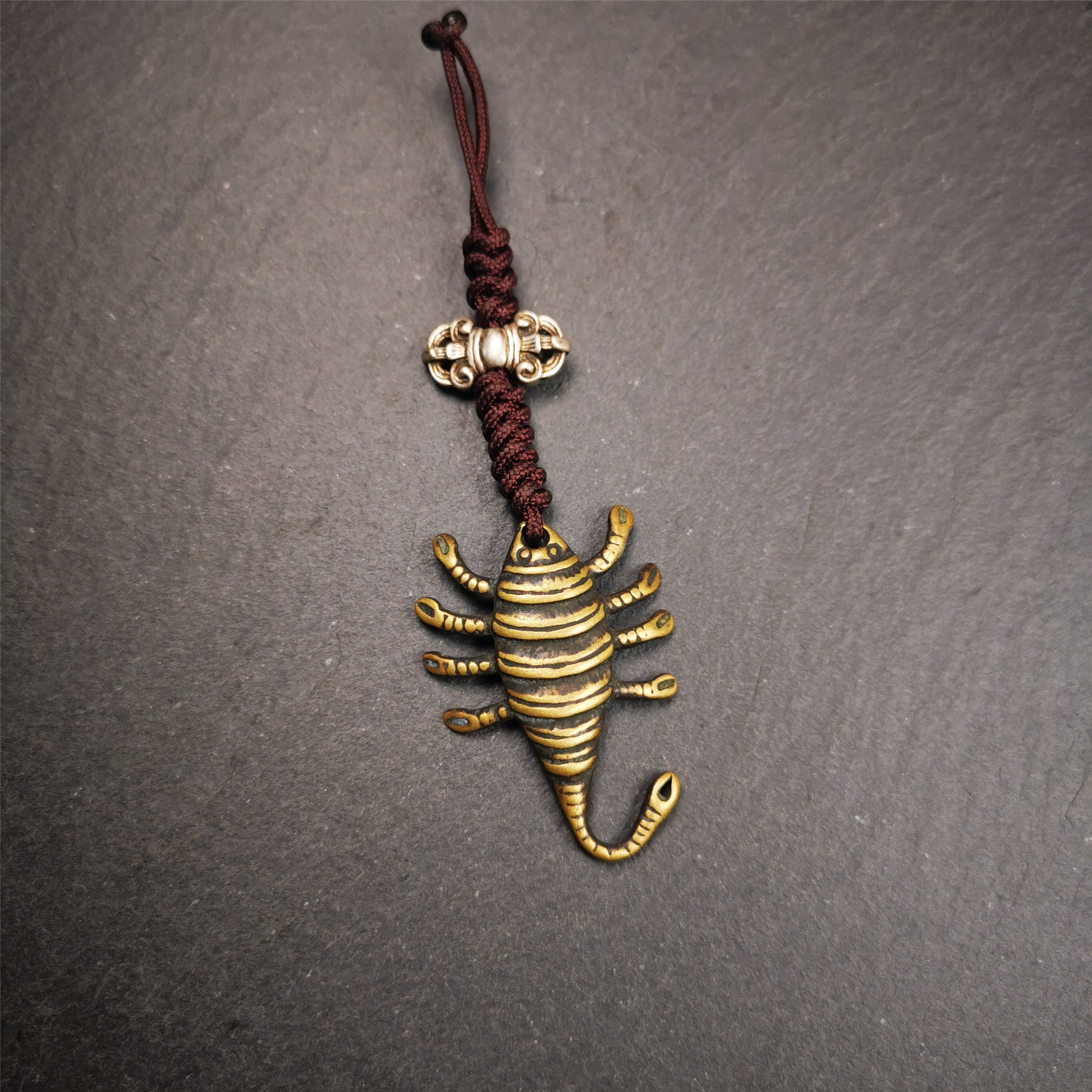 This scorpion amulet is collect from Baiyu Tibet,it is made of brass,yellow color,size is 1.57 inch. You can make it into a necklace pendant, bag hanging,keychain, or just put it on your desk,as an ornament.