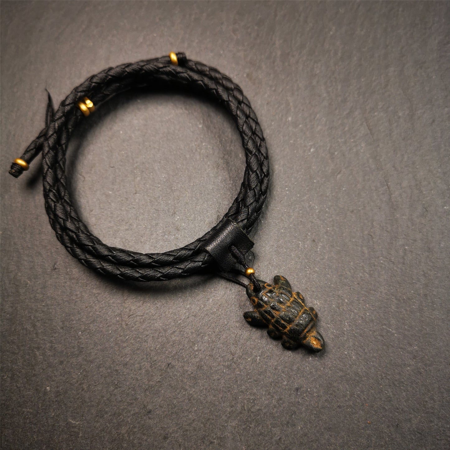 This unique obsidian carved Scorpion Guru pendant is made by Tibetan craftsmen in Hepo Township, Baiyu County, the birthplace of the famous Tibetan handicrafts. It's made of obsidian,black color,1.1 inch height. You can make it into necklace,or mala pendant.