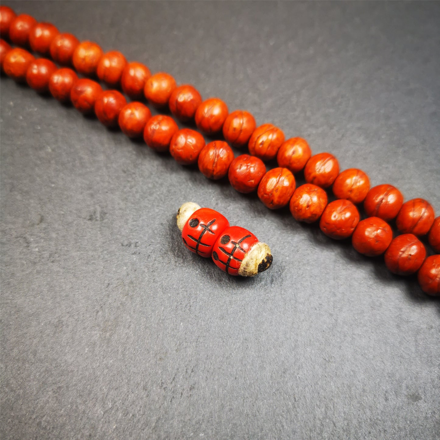 These marker beads were handmade by Tibetan craftsmen and come from Hepo Town, Baiyu County, the birthplace of the famous Tibetan handicrafts. It is made of plastic,carved skull pattern,red color,size is 0.4" × 0.3".
