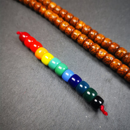 The price is 1 pair of 2 Strings Sherpa Glaze Beads,total 24 beads.(each string 12 beads)  These marker beads were handmade by Tibetan craftsmen and come from Hepo Town, Baiyu County, the birthplace of the famous Tibetan handicrafts. It is made of sherpa glaze,rainbow color,size is 0.31" × 0.24". Fit for 6-8mm mala (The reference in the photo is 8mm lotus seed mala)
