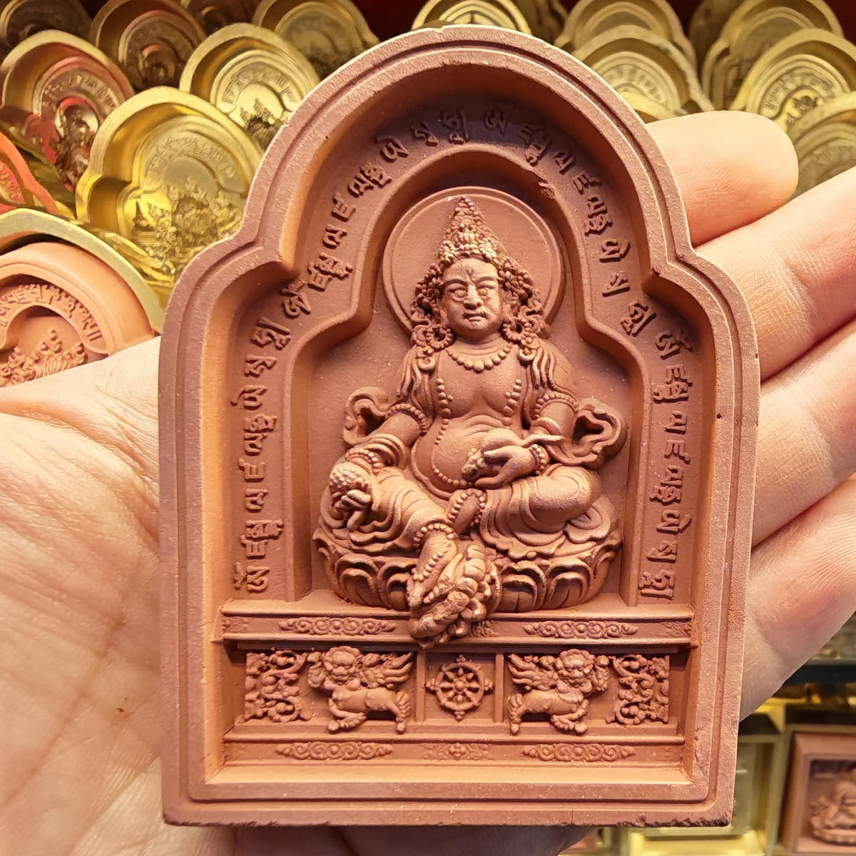 Bordered Yellow Jambhala Tsa Tsa Mold - Tibetan tsa tsa mold, close-up detail