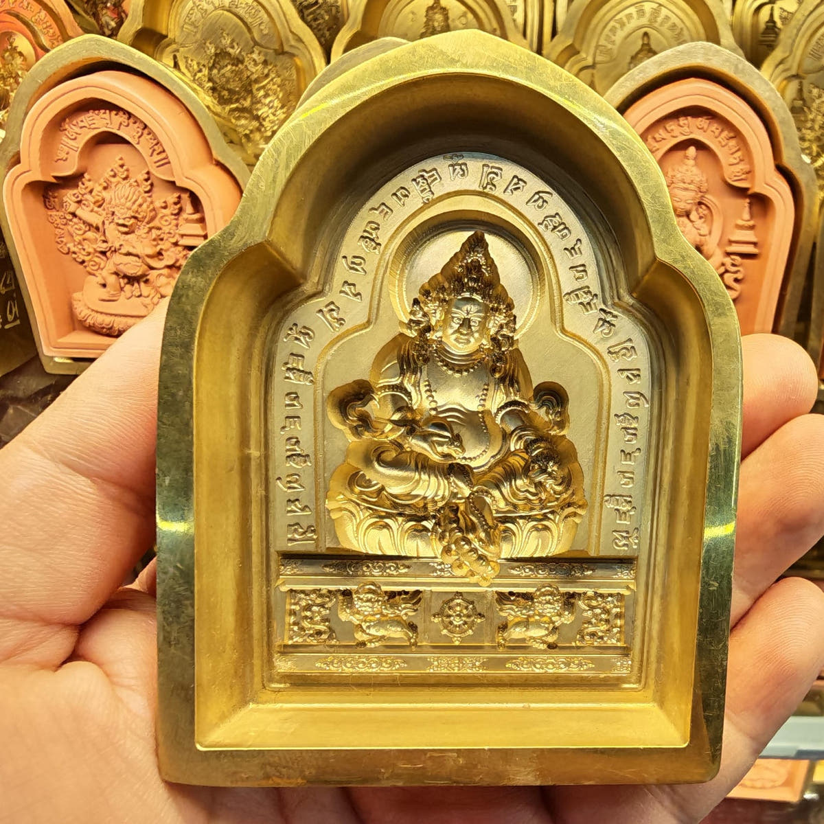 Bordered Yellow Jambhala Tsa Tsa Mold - Tibetan tsa tsa mold, detailed view