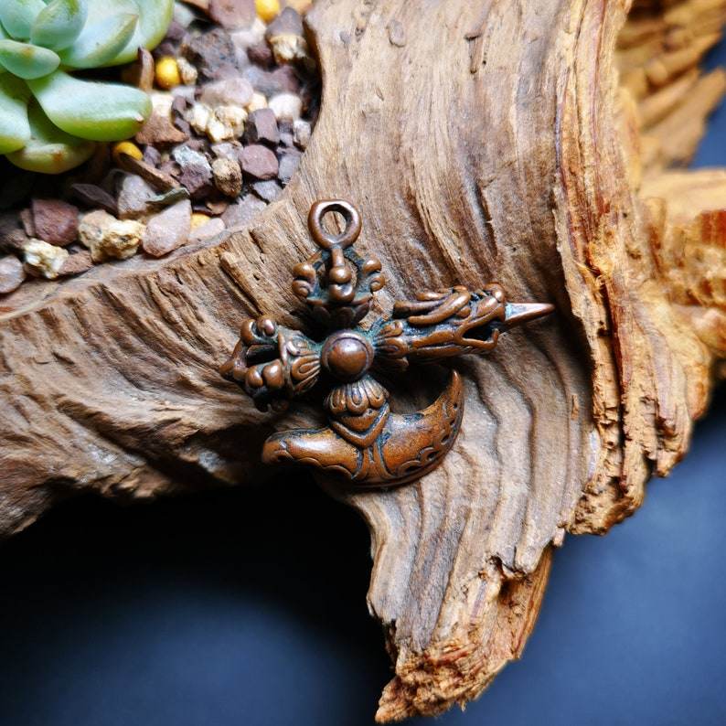 Amulet,Cross Kartika knife of the dakinis and Kila Dorje Phurba - Tibetan Buddhist amulet, close-up detail