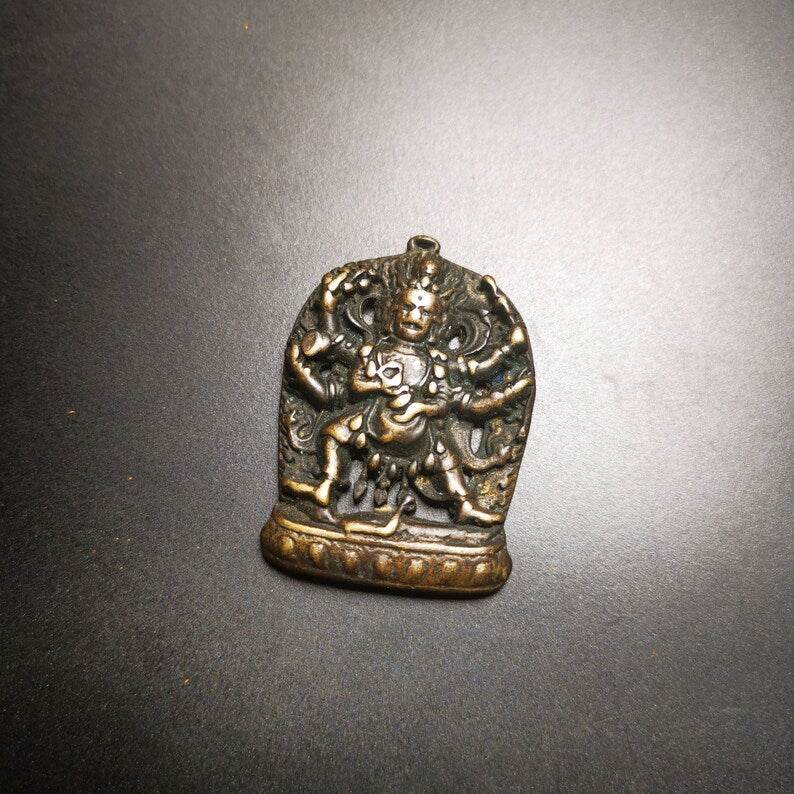 Thokcha Amulet Pendant,Mahakala, Buddhist Protector Deity, Made of Thunder Iron - Tibetan Buddhist amulet, close-up detail