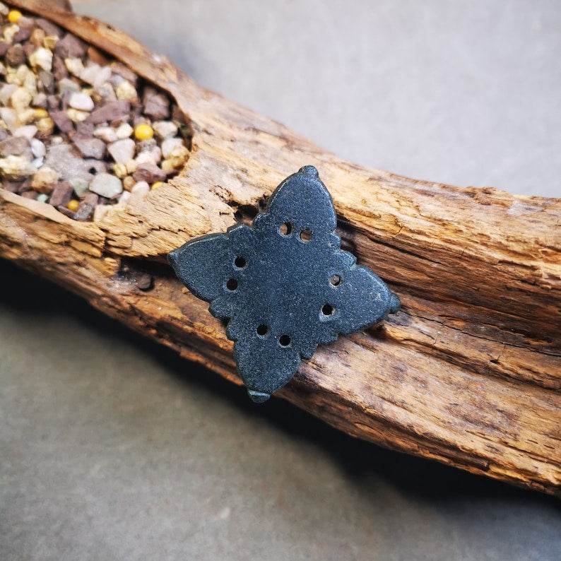 Hand Carved Cross Vajra Amulet Badge, Tibetan Buddhist Pendant, Made of Obsidian - Tibetan Buddhist amulet, close-up detail